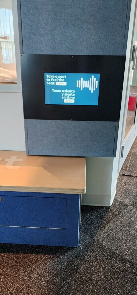 Close-up of the listening booth touchscreen interface showing genre selection.