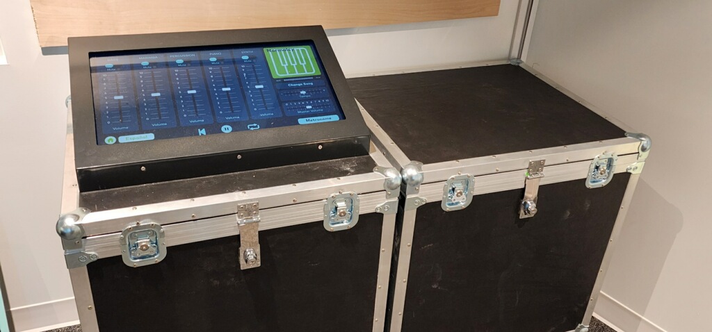 Multitrack sound mixer exhibit application running on a touchscreen mounted in a road case at the Florida Children's Museum.